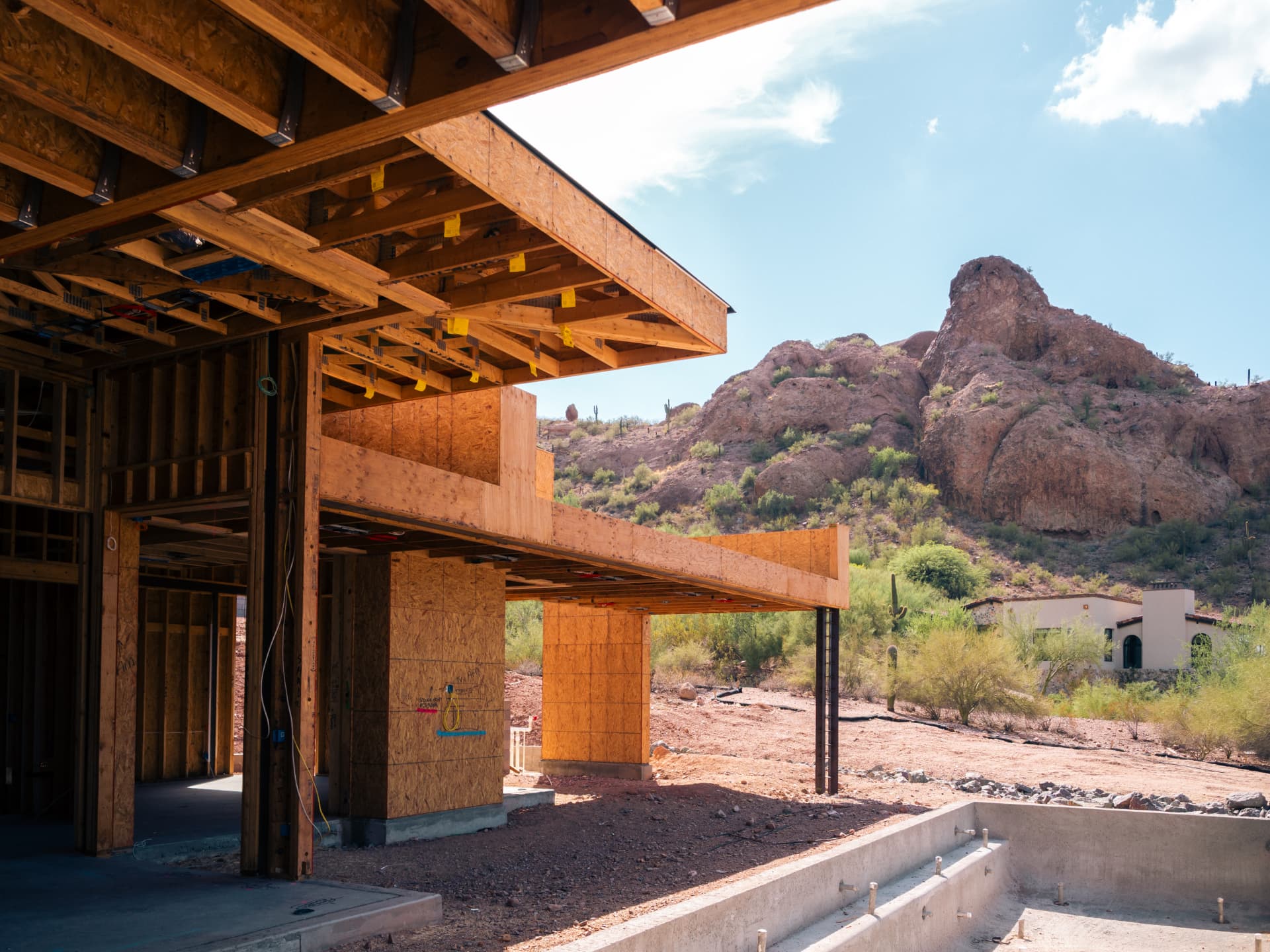Luxury residence framing under construction against the Camelback Mountain ridgeline
